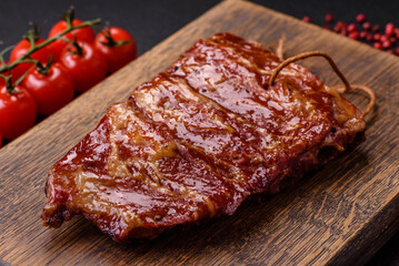 Delicious juicy grilled ribs baked on the grill with salt, spices and herbs