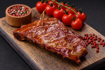 Delicious juicy grilled ribs baked on the grill with salt, spices and herbs