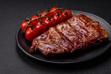 Delicious juicy grilled ribs baked on the grill with salt, spices and herbs