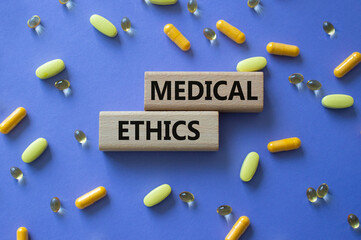 Medical Ethics symbol. Concept word Medical Ethics on wooden blocks. Beautiful purple background...
