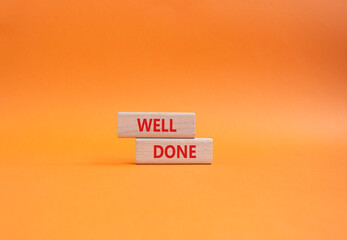 Naklejka premium Well done symbol. Wooden blocks with words Well done. Beautiful orange background. Business and Well done concept. Copy space.