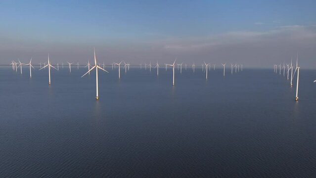 Wind Turbines park in the Lake IJsselmeer in Flevoland Netherlands, Offshore Windmill Windmill Farm in the Sea, Sunset