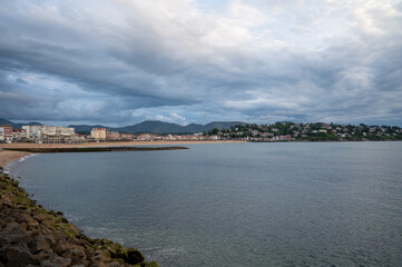 Fototapeta premium Ciboure and Saint Jean de Luz bay and sandy beach on Basque coast on sunset, famous resorts, known for beautiful architecture, nature and cuisine, South of France, Basque Country