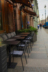 brown outdoor cafe chairs and tables in summer