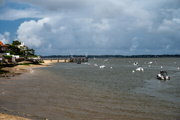Walking on beach promenade in Arcachon, vacation destination town on Atlantic coast with beatiful parks, villas, streets and sandy beach, France