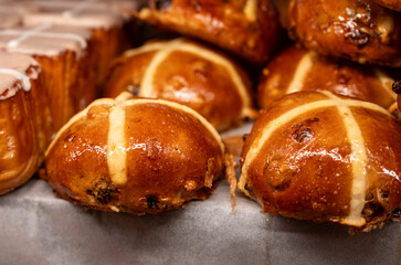 Traditional British Easter food, fresh baked cross buns with raisins or apples
