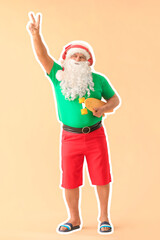 Santa Claus with skateboard on color background. Concept of vacation