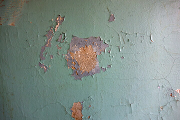 A photo of the texture of an old wall in the entrance of an apartment building.Peeling walls in the...