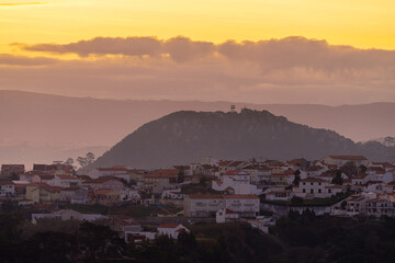 Silhouetted Hills and Town of Nazar&eacute; at Sunset