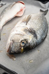 Uncooked fish on a baking tray