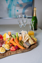 Brunch table with charcuterie board champagne and orange juice for mimosas