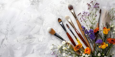Obraz premium Minimalistic composition: Minimal creative bouquet with flowers and paint brushes for paint. Minimal playful concept of spring and creativity. High quality photo