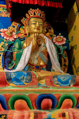 Naklejka premium Buddhist temple interior featuring ornate decorations, statues of buddha, and traditional architecture. Serene atmosphere with intricate details, golden accents, religious and cultural artifacts Nepal