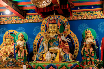 Buddhist temple interior featuring ornate decorations, statues of buddha, and traditional architecture. Serene atmosphere with intricate details, golden accents, religious and cultural artifacts Nepal