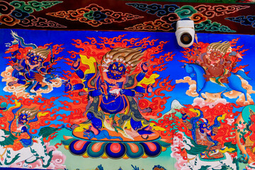 Buddhist temple interior featuring ornate decorations, statues of buddha, and traditional...