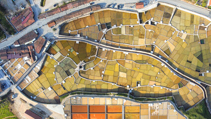 Aerial view of colorful traditional salt pans in a rural landscape