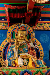 Buddhist temple interior featuring ornate decorations, statues of buddha, and traditional architecture. Serene atmosphere with intricate details, golden accents, religious and cultural artifacts Nepal