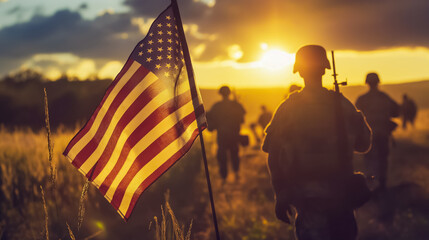 Silhouettes of American Milatery Solgers Walking at Sunset with American Flag, Inspirational Rural America Theme for Patriotic Events, Heroic Military Action Stock Photo for Memorial Day, Veterans Day