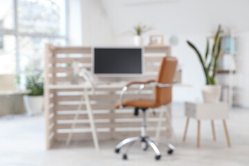 Blurred view of clinic with reception desk and plants