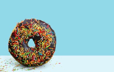 Creative Colourful glazed sweet doughnut with sprinkles