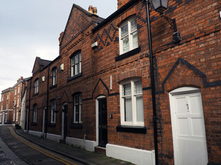 street of old traditional red brick victorian houses on a road in Chester England