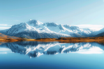 A crystal clear mountain lake with a reflection of the surrounding snow-capped peaks and blue sky. A fascinating lake and mountain view with mountains covered in snow.