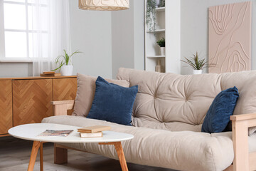 Stylish interior of living room with soft sofa and coffee table