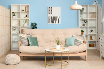 Interior of light living room with sofa and cushions