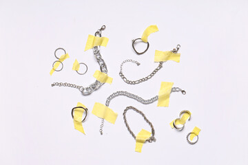 Adhesive tape with beautiful silver jewelry on white background