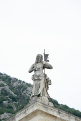 Fototapeta premium Old statue on the roof of a building in Montenegro 