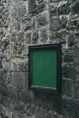 Green painting on the ancient stone wall in kotor