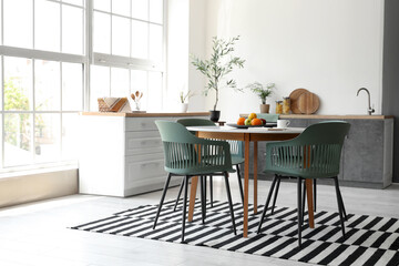 Interior of stylish room with dining table and counters