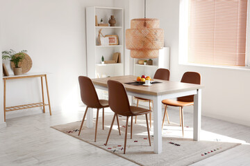 Interior of light room with dining table and shelf units