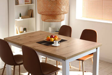 Fruits with cup of coffee on dining table in room