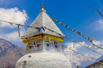 Stupa with Buddha eyes in Nepal. Religious building of buddhism pagoda in the high Himalaya mountains and Kathmandu capital city. Sacred place of Buddhism with prayer flags in beautiful peaceful place