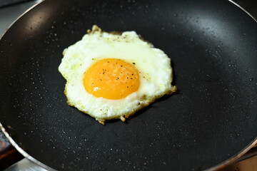 fried egg in frying pan healthy food runny yolk