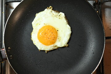 fried egg in frying pan healthy food runny yolk