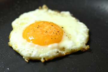 fried egg in frying pan healthy food runny yolk