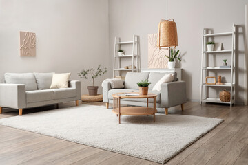 Interior of light living room with grey sofas, table and shelf units