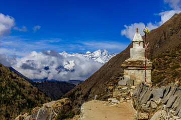 Fototapeta premium Stupa with Buddha eyes in Nepal. Religious building of buddhism pagoda in the high Himalaya mountains and Kathmandu capital city. Sacred place of Buddhism with prayer flags in beautiful peaceful place