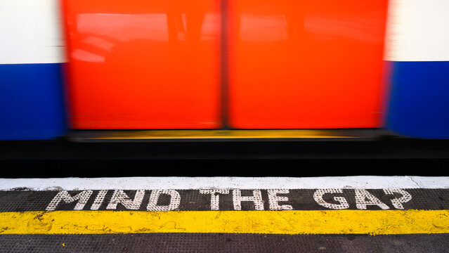 London, UK - March 23, 2024; Iconic London Transport caution sign on underground to Mind the Gap  between train and platform edge