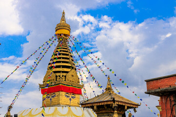 Stupa with Buddha eyes in Nepal. Religious building of buddhism pagoda in the high Himalaya mountains and Kathmandu capital city. Sacred place of Buddhism with prayer flags in beautiful peaceful place