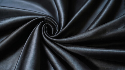 Fototapeta premium Empty smooth black silk fabric folded cloth background, luxurious fabric textile decoration for poster, banner or cover design,