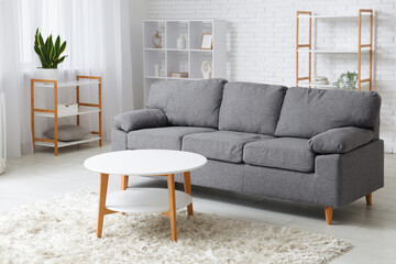 Comfortable sofa and coffee table in interior of living room