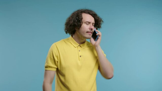 Angry handsome man quarreling, screaming talking on mobile phone. Guy in stress