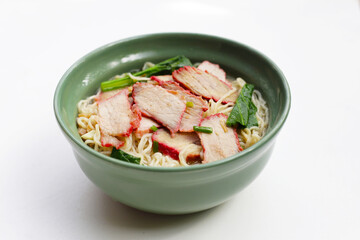 Chinese egg noodles with red pork in hot soup