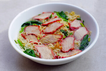 Chinese egg noodles with red pork in hot soup