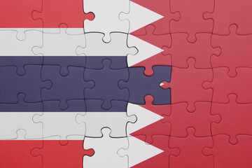 puzzle with the colourful national flag of thailand and flag of bahrain .