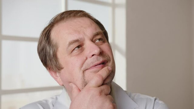 Portrait of thoughtful businessman having brain storm coming up with business plan for startup idea in office.
