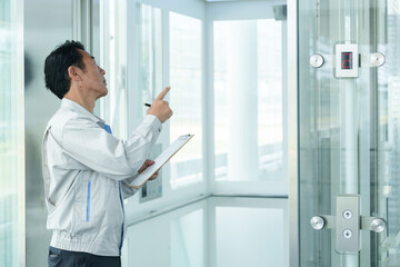 エレベーターの点検をする作業員 © taka